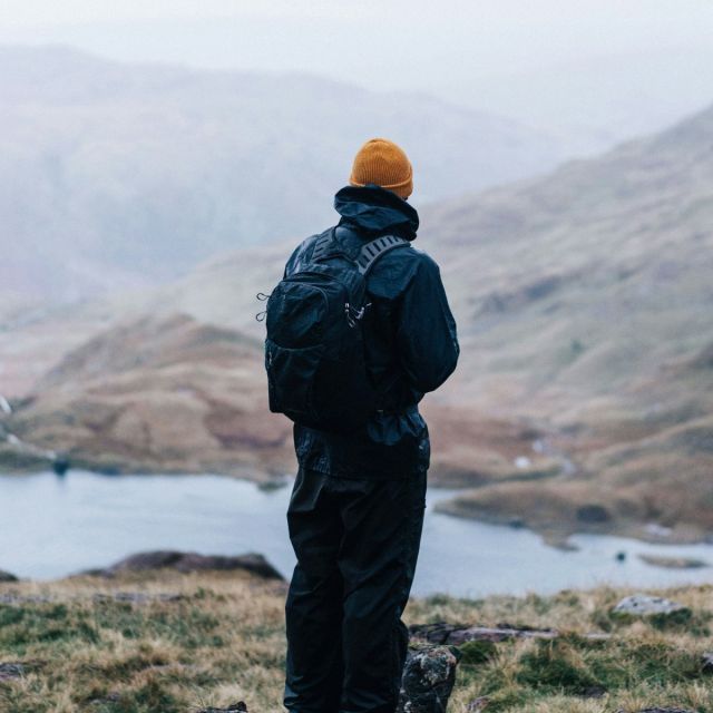 Hiker with the Summit 45L looking over a mountain lake